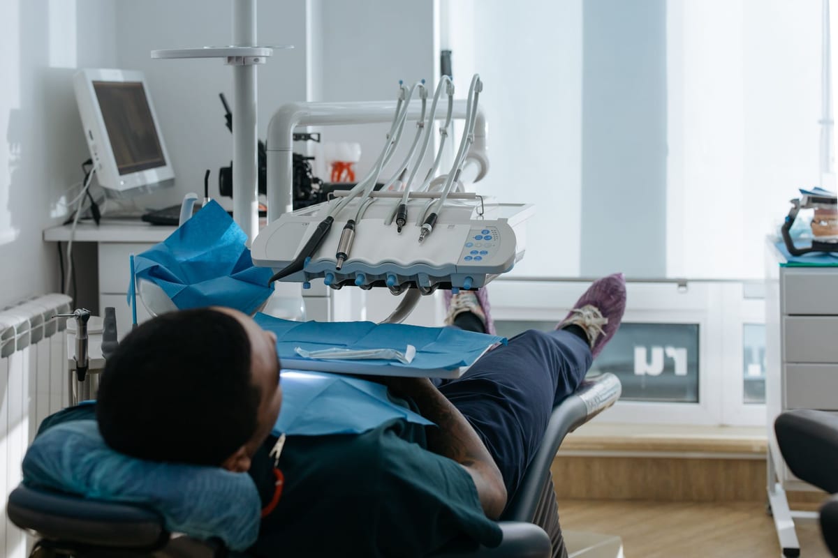 A patient settled back in the treatment chair with the equipment arm alongside